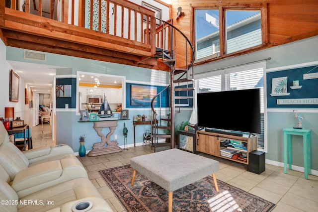 living room with light tile patterned flooring and a high ceiling