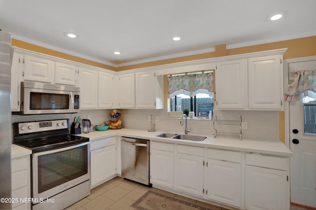 kitchen featuring sink, decorative backsplash, light tile patterned floors, white cabinetry, and stainless steel appliances