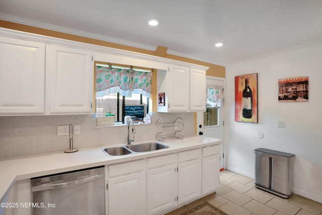 kitchen featuring stainless steel dishwasher, white cabinets, and sink