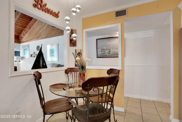 dining area featuring light tile patterned floors, wooden ceiling, and ornamental molding