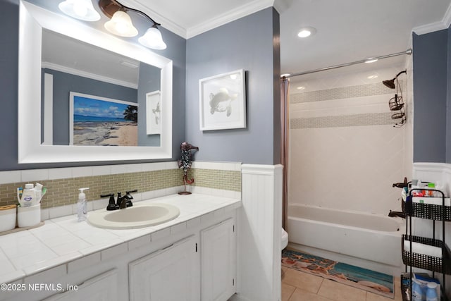 full bathroom featuring vanity, tile patterned floors, tiled shower / bath combo, toilet, and ornamental molding