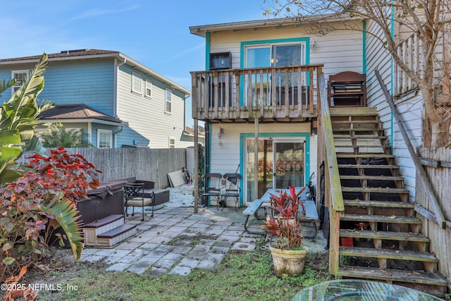 back of house featuring a patio and a hot tub