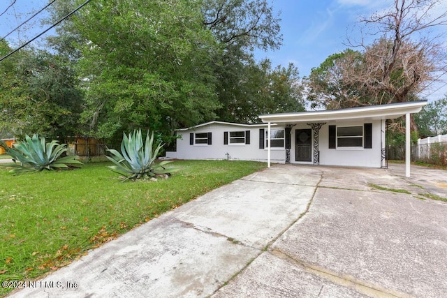 ranch-style house featuring a front yard and a carport