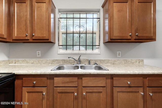 kitchen featuring sink and black electric range oven