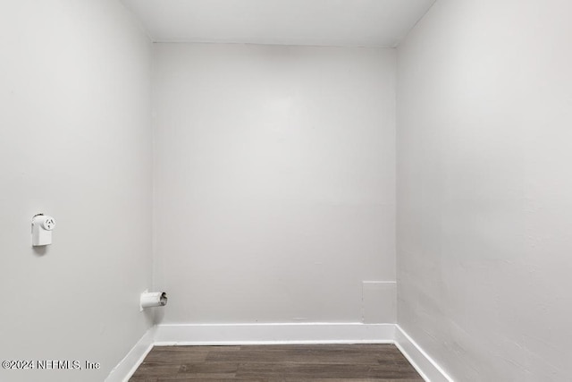 clothes washing area featuring dark hardwood / wood-style floors