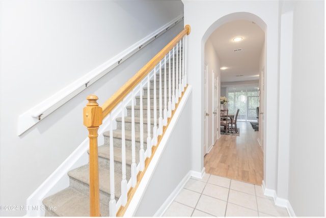 stairs with tile patterned floors