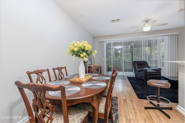 dining area featuring light wood-type flooring, vaulted ceiling, and ceiling fan