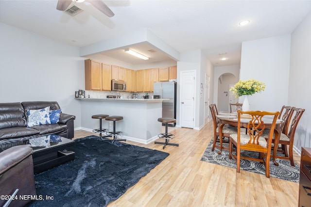 living room with ceiling fan and light wood-type flooring