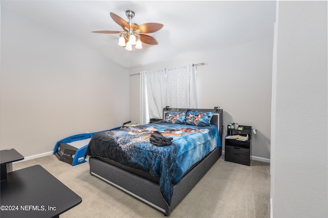 carpeted bedroom featuring ceiling fan and vaulted ceiling