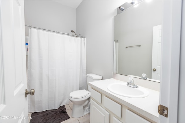 bathroom featuring tile patterned flooring, vanity, and toilet