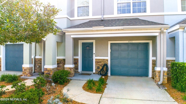 entrance to property with covered porch and a garage