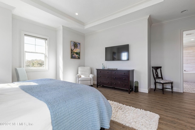 bedroom featuring dark hardwood / wood-style floors, crown molding, and ensuite bathroom