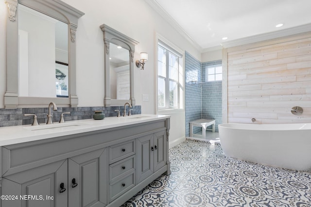 bathroom featuring vanity, a bathtub, and ornamental molding