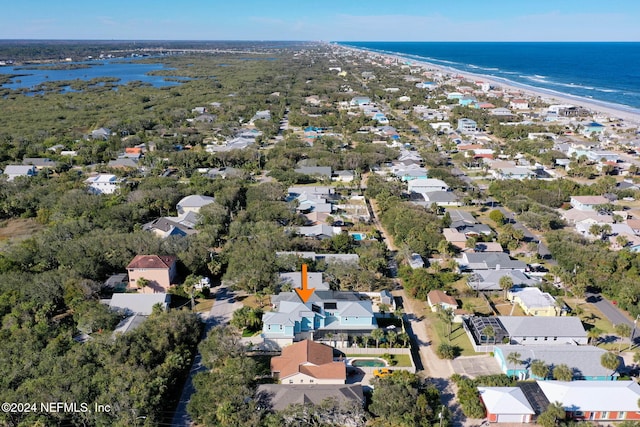 bird's eye view featuring a water view and a beach view