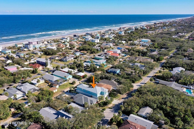 drone / aerial view featuring a water view and a beach view