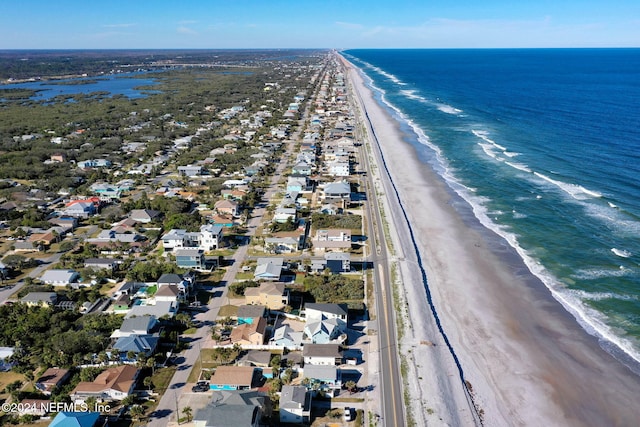 drone / aerial view featuring a water view and a beach view