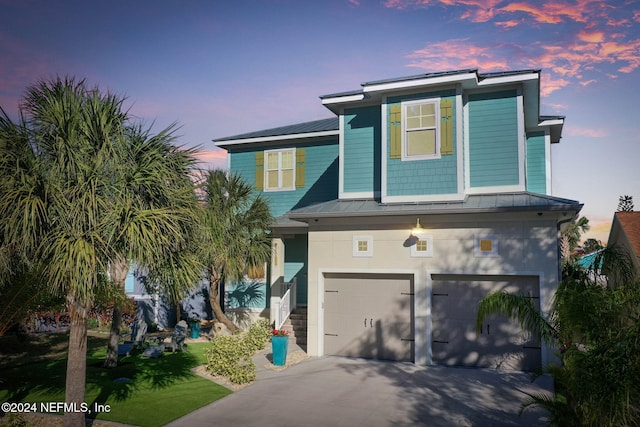 view of front of house with a yard and a garage