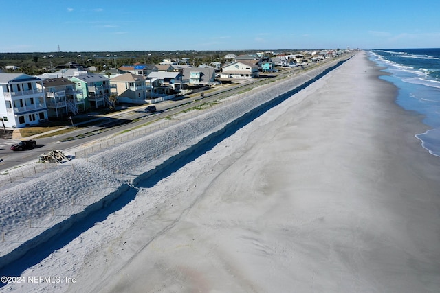 birds eye view of property featuring a view of the beach and a water view