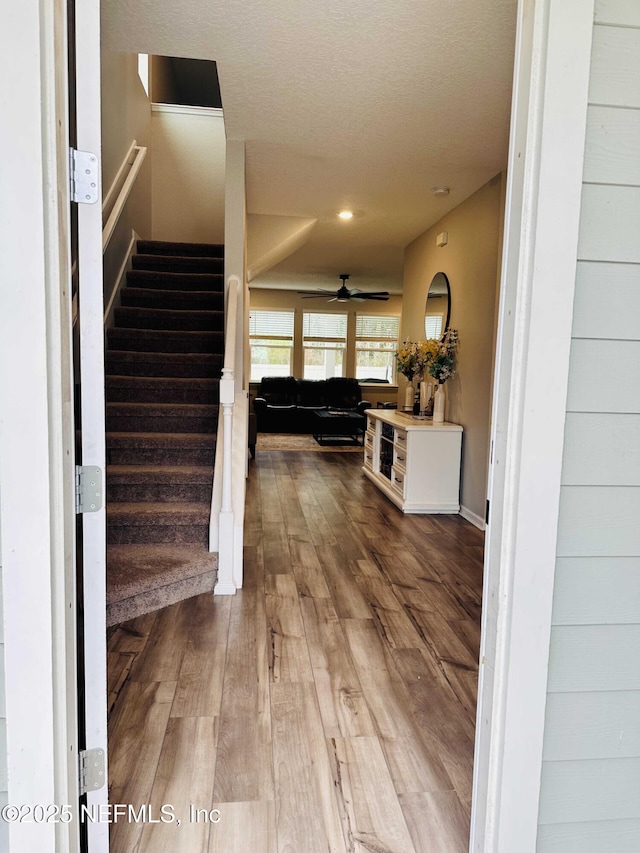 interior space with wood-type flooring and ceiling fan