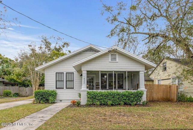 bungalow featuring a front yard and a sunroom