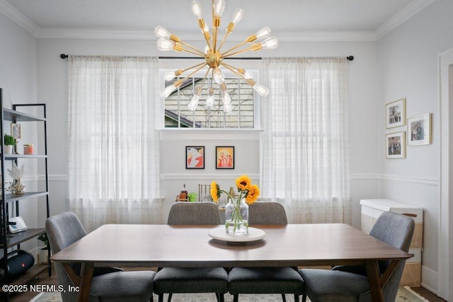 dining space featuring a healthy amount of sunlight, ornamental molding, and an inviting chandelier