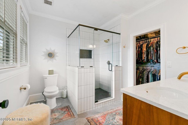 bathroom with an enclosed shower, ornamental molding, vanity, tile patterned flooring, and toilet