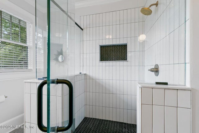 bathroom featuring crown molding and walk in shower