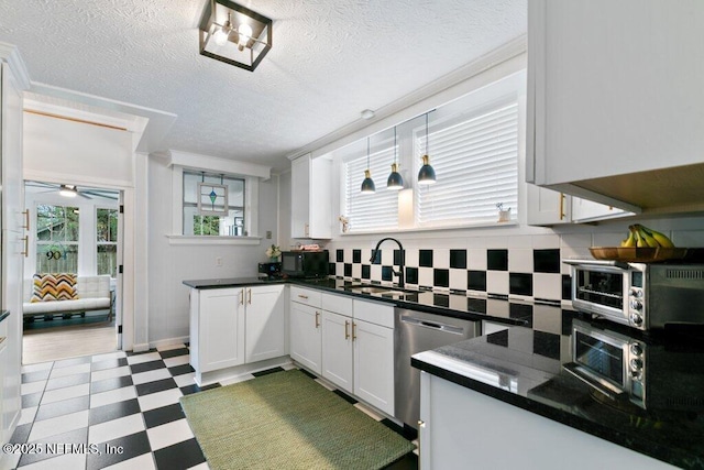 kitchen featuring dishwasher, white cabinets, sink, ceiling fan, and a textured ceiling