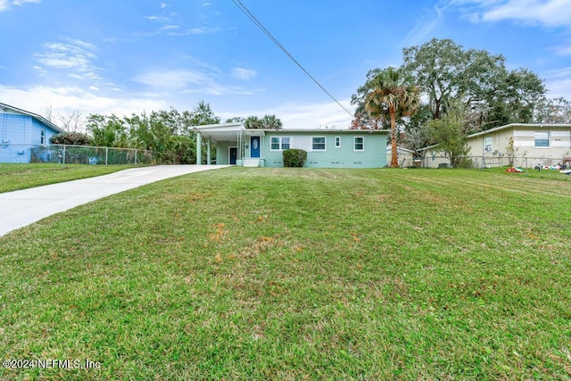 view of front facade with a front lawn and a carport