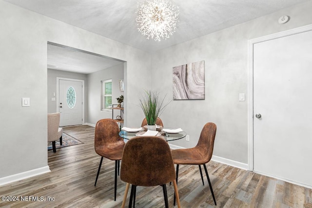 dining room featuring hardwood / wood-style floors and a chandelier