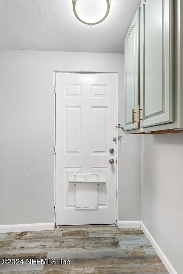 doorway to outside with wood-type flooring