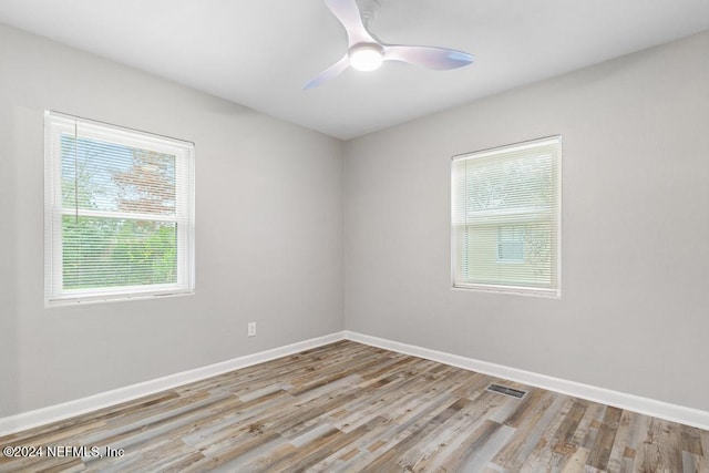 spare room featuring ceiling fan and light hardwood / wood-style flooring