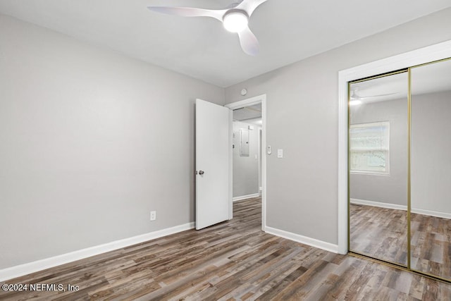 unfurnished bedroom with hardwood / wood-style floors, a closet, and ceiling fan