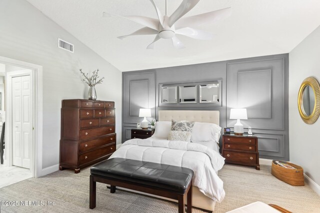 carpeted bedroom featuring vaulted ceiling and ceiling fan