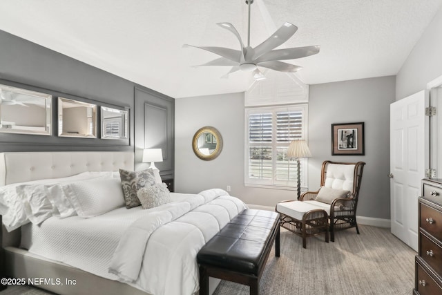 bedroom with ceiling fan and a textured ceiling