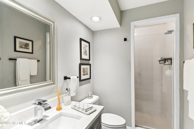 bathroom featuring vanity, an enclosed shower, and toilet