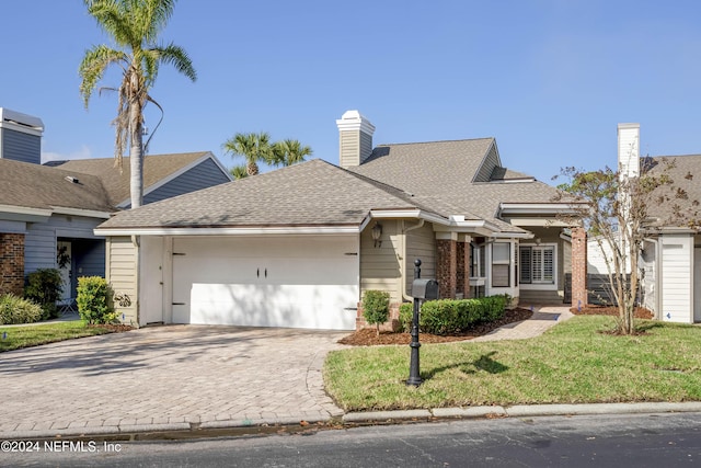 single story home featuring a front yard and a garage