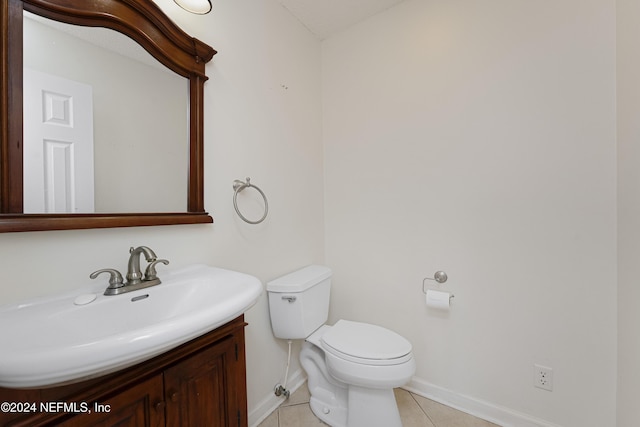 bathroom featuring toilet, vanity, and tile patterned floors