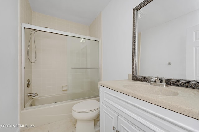 full bathroom featuring tile patterned floors, vanity, toilet, and tiled shower / bath combo