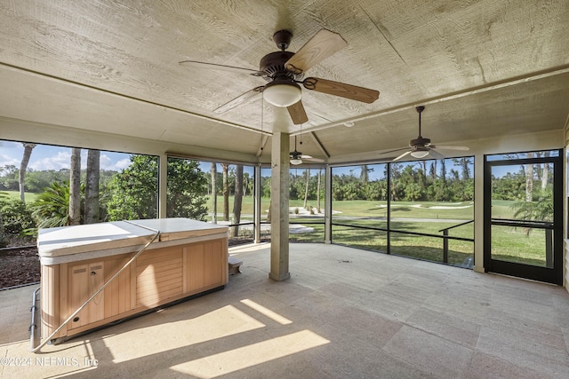 unfurnished sunroom with ceiling fan