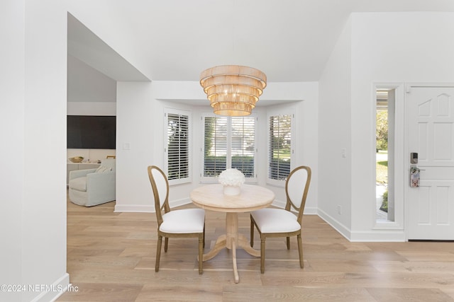 dining space with a chandelier and light hardwood / wood-style floors