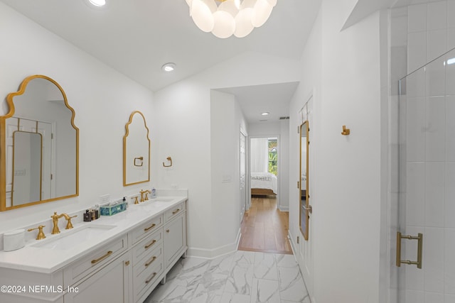 bathroom with lofted ceiling, vanity, and an enclosed shower