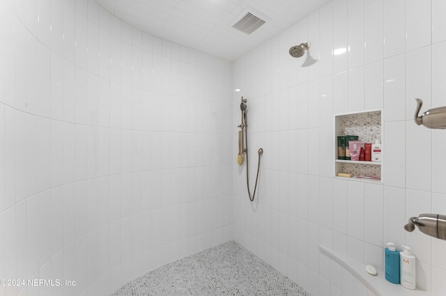 bathroom with tiled shower