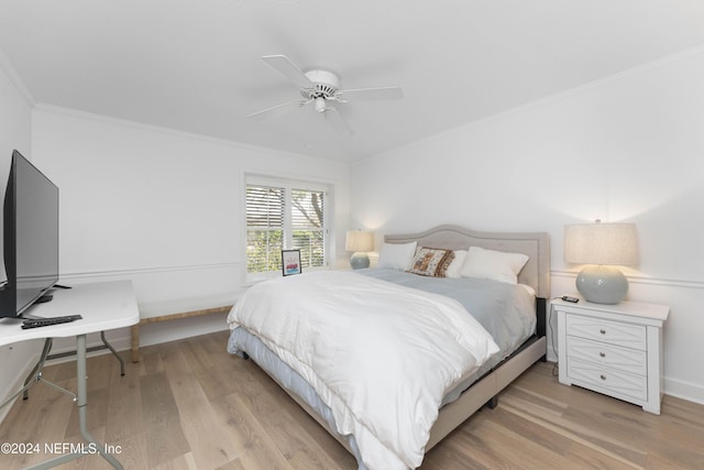 bedroom featuring ceiling fan, light hardwood / wood-style flooring, and ornamental molding