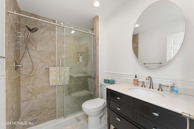 bathroom featuring vanity, toilet, and an enclosed shower