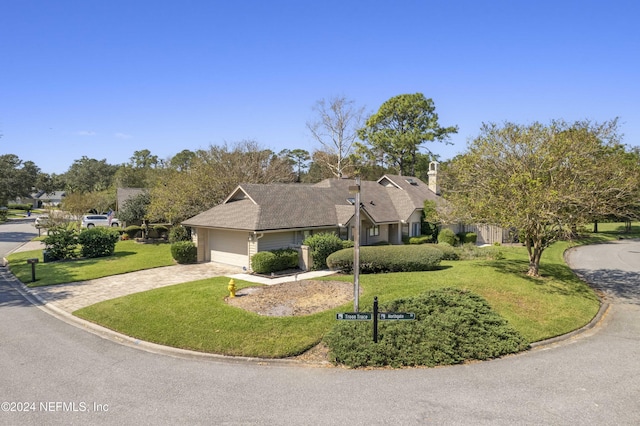 view of front of home featuring a front yard and a garage