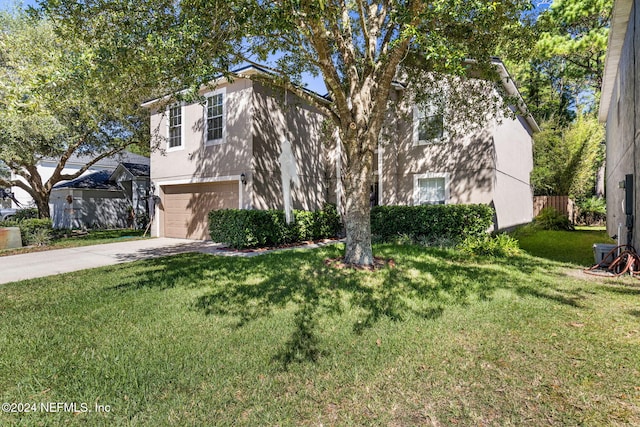 view of front of home featuring a front lawn and a garage