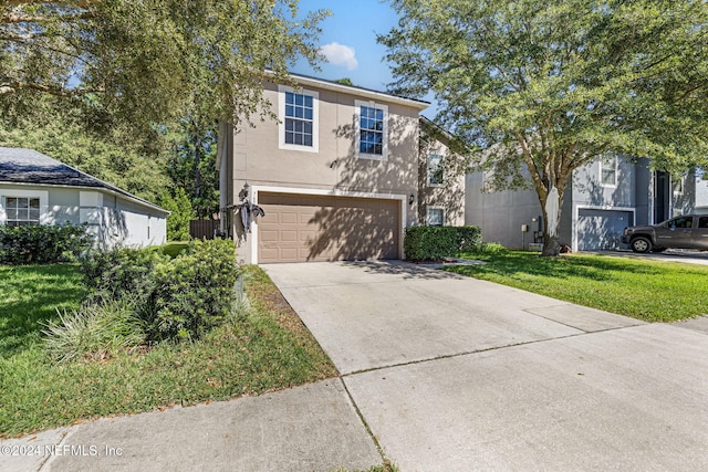 view of front of property featuring a garage and a front lawn