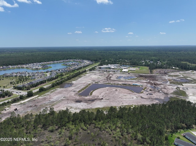 aerial view with a water view and a view of trees