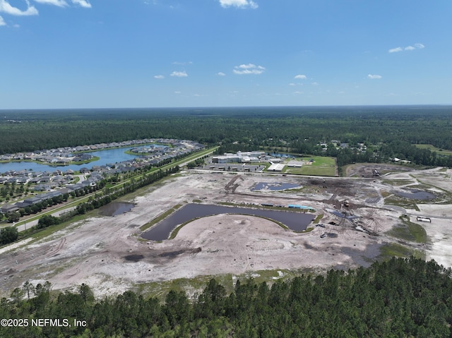 aerial view with a forest view and a water view